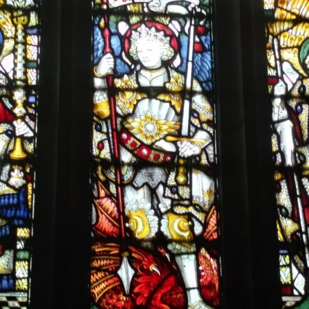 Stained glass window showing St George in armour with a red dragon at his feet.